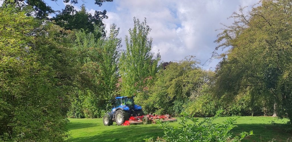 A tractor mowing the park